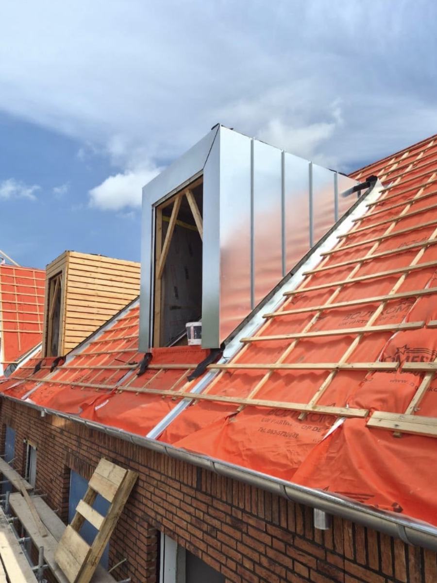 Met zink beklede dakkapel op een dak met nieuwe onderdakfolie en panlatten